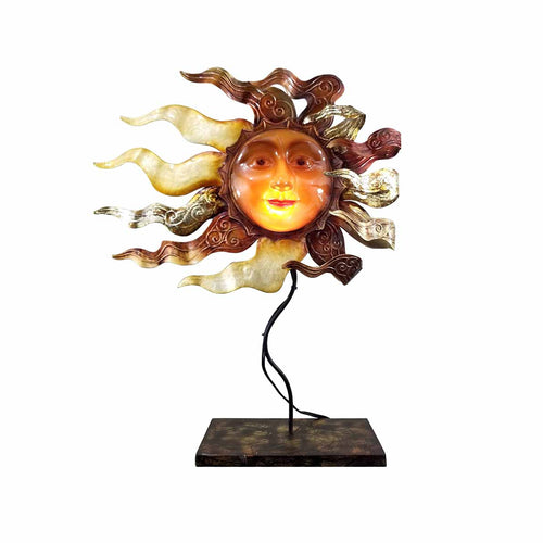 A whimsical sun with a smiling face and golden metal streamers representing sun rays. 